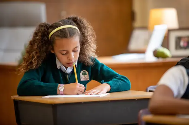 3rd grade girl working on her reflection in arts class