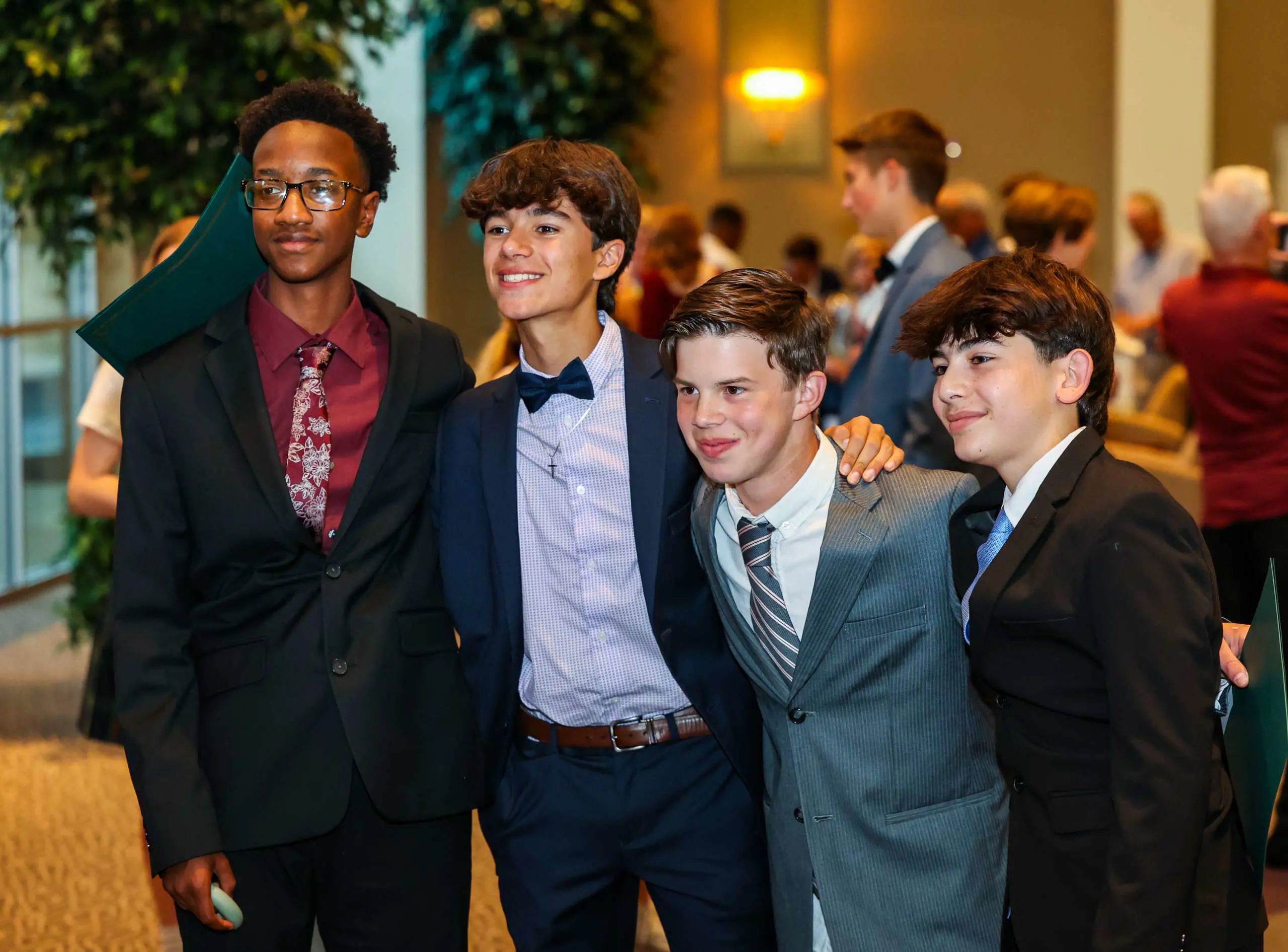 Friends pose for a photograph together at their 8th Grade graduation.