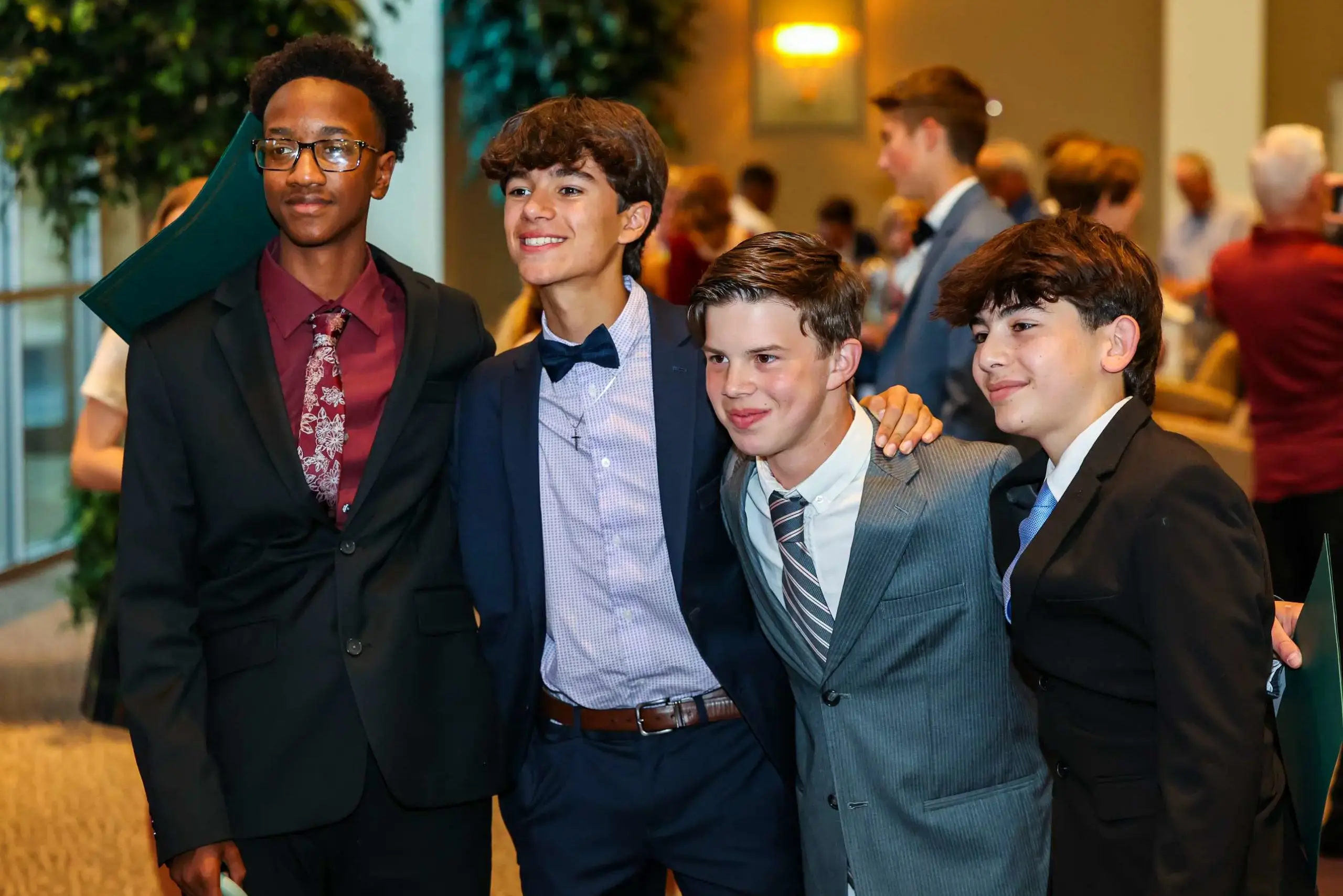 8th Grade students pose for a photograph together at their graduation.