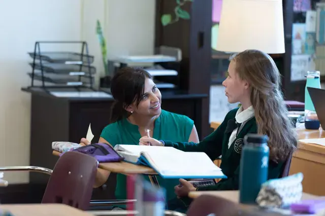 Teacher supporting middle school student