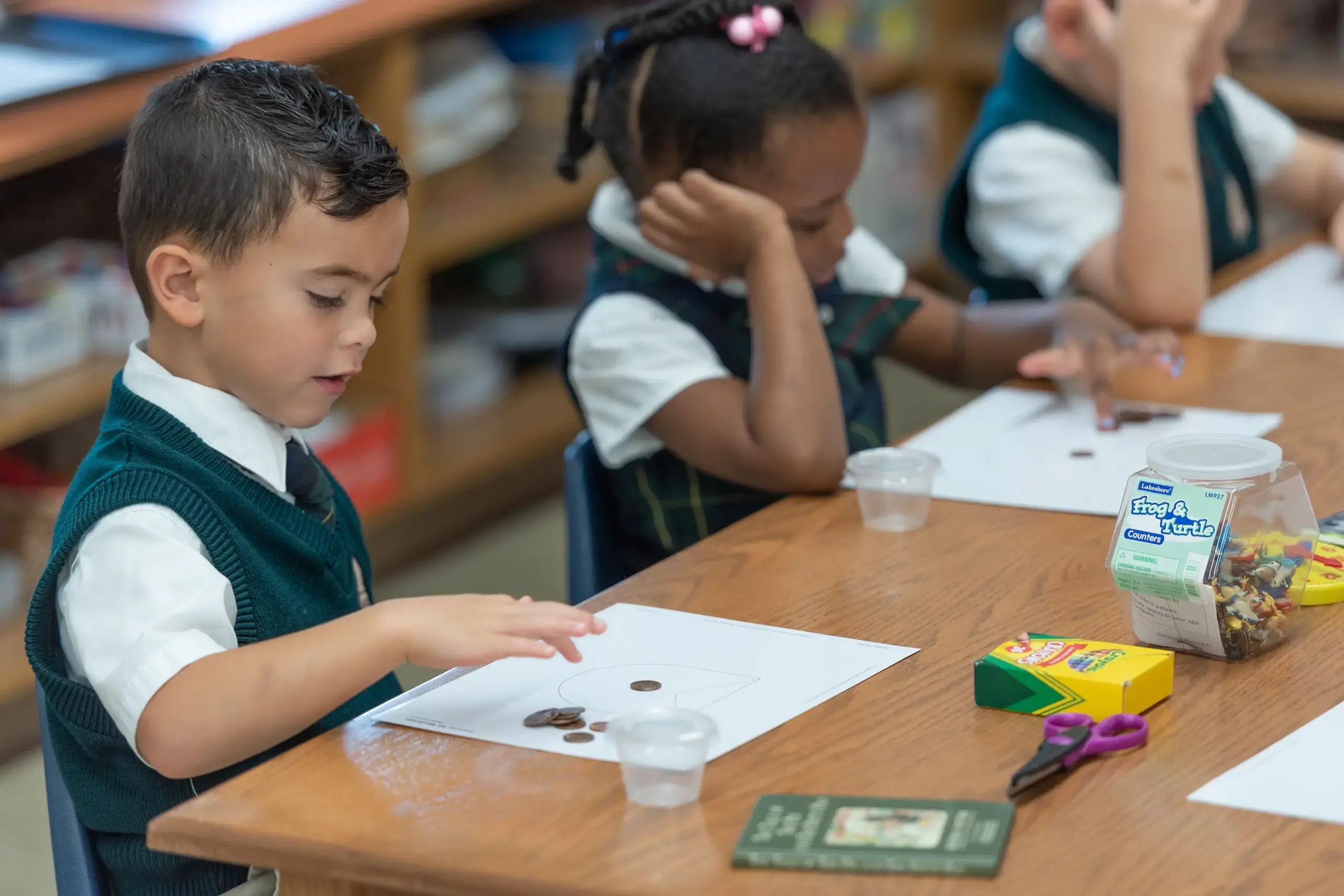 Student counting coins in a math class.