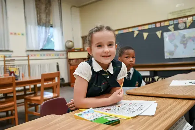 Girl smiles over her work