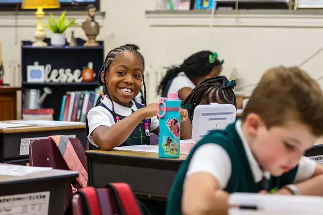 girl smiling at her desk