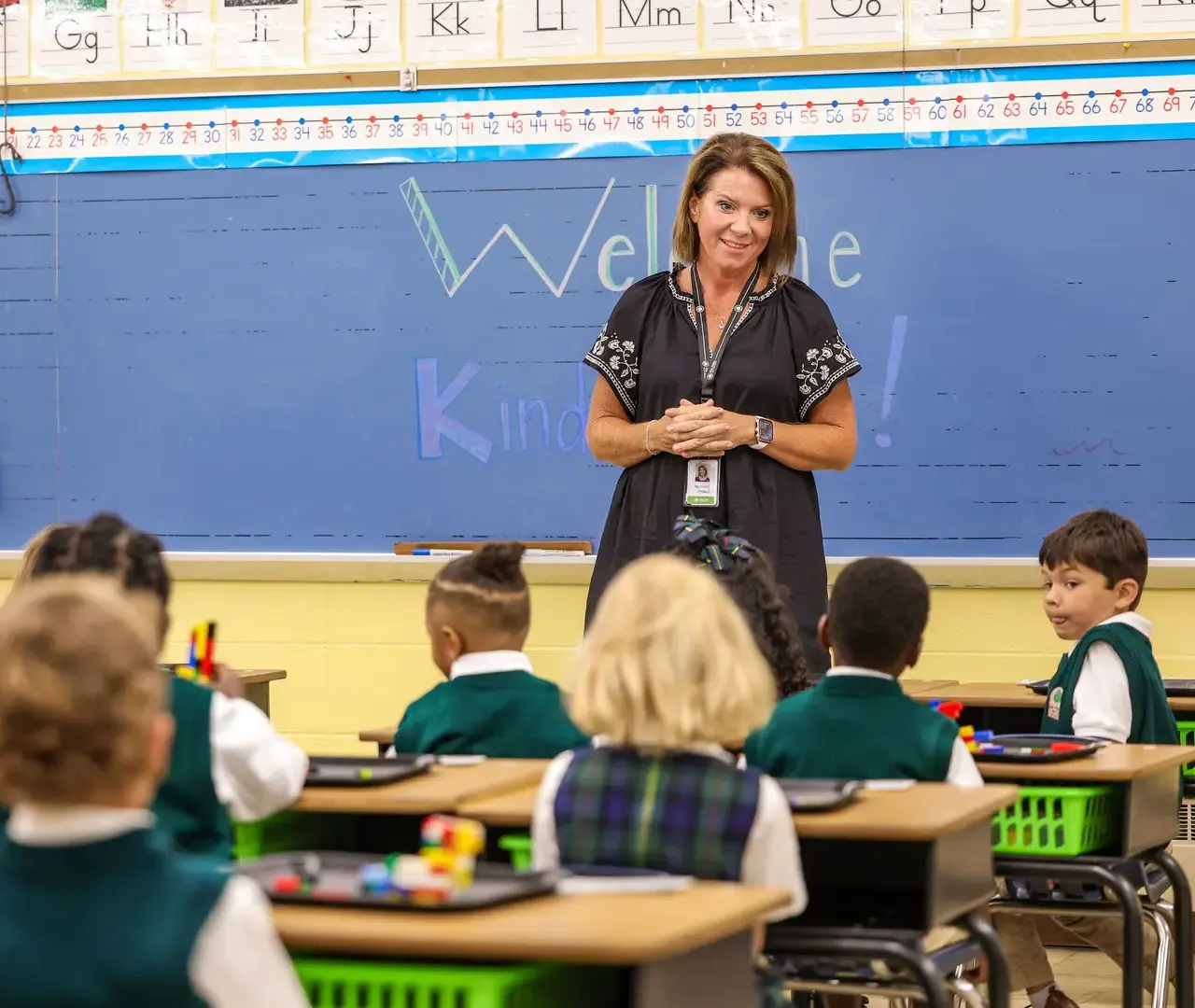 Kindergarten teacher welcoming class on the first day