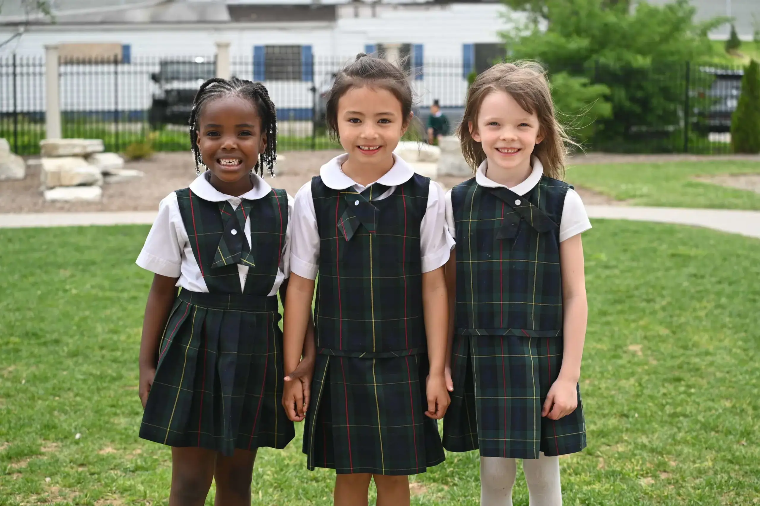 Pre-K Girls holding hands on the playground.