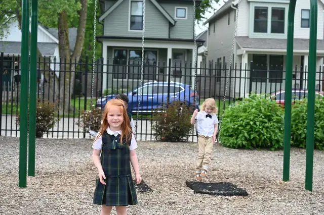 two PreK students near swings