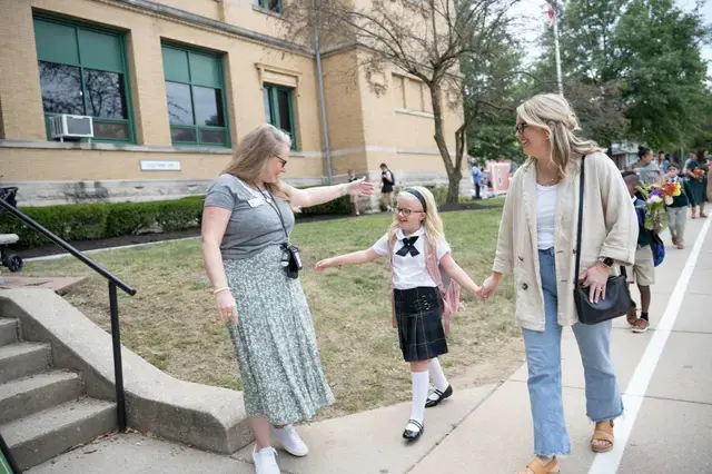 student hugs teacher on the way into school